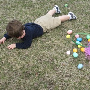 Kid laying after fall on a grass