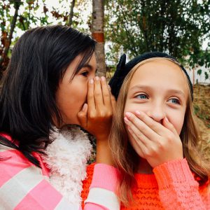 Two girls gossiping