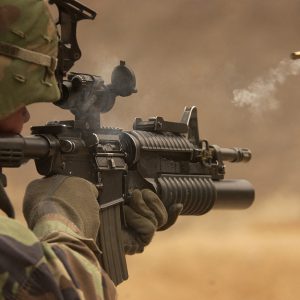 A soldier fires a rifle