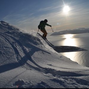 A person skis down a mountain