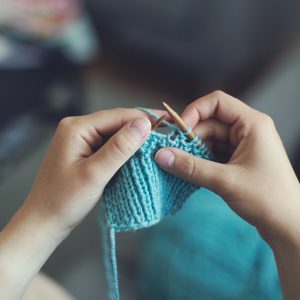 A child learns to knit