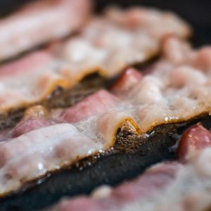 Bacon is fried in a pan