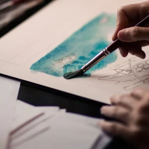 A person paints a drawing