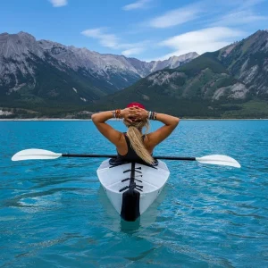 A woman in a kayak with a view of the mountains